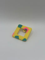 Pin’s de lunette carré jaune fleuri